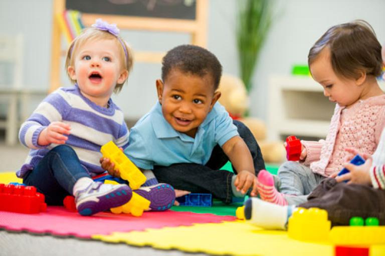 3 toddlers playing together at nursery