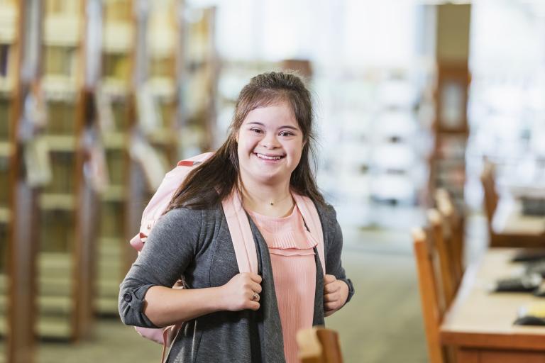 Teenage girl with down syndrome at the library